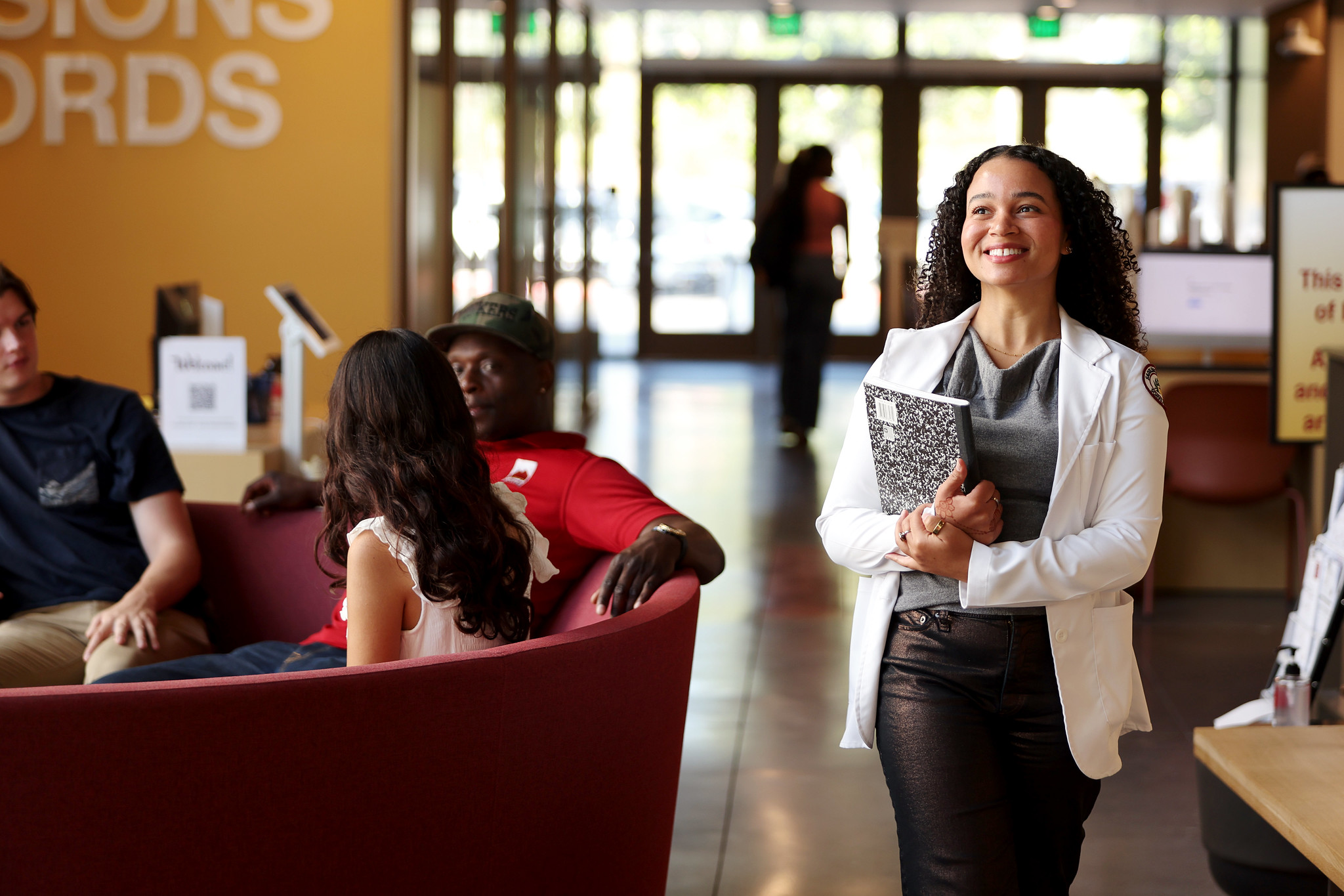A Saddleback College student walks through the Gateway Building, the central hub that serves students with key resources such as the Transfer Center, Counseling, and Admissions & Records.