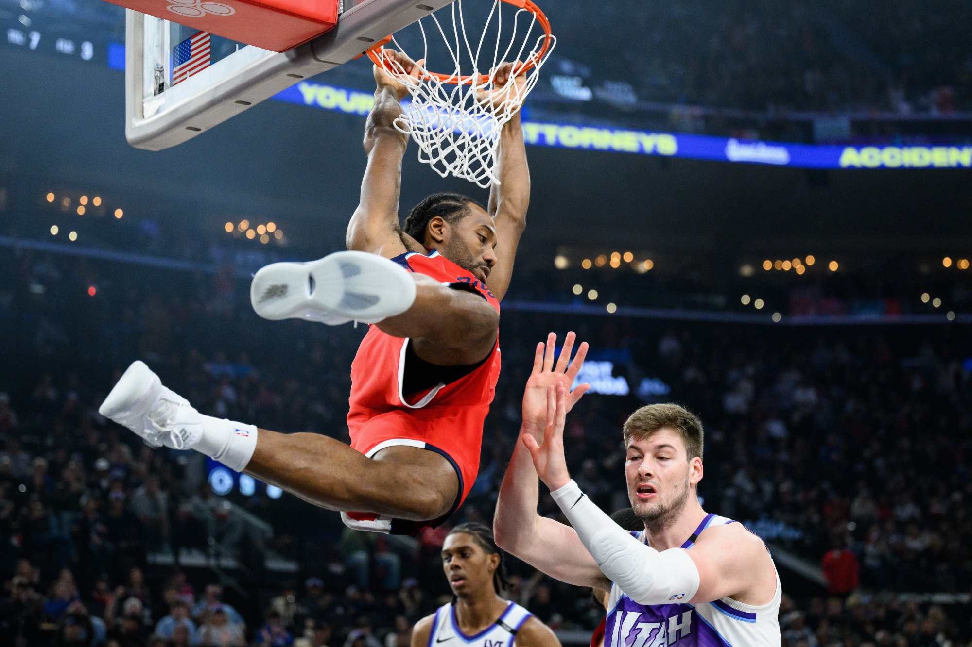 Clippers forward Kawhi Leonard dunks over Utah’s Kyle Filipowski during the first half Thursday, Jan. 1, 2026, at Intuit Dome. (AP Photo/William Liang)
