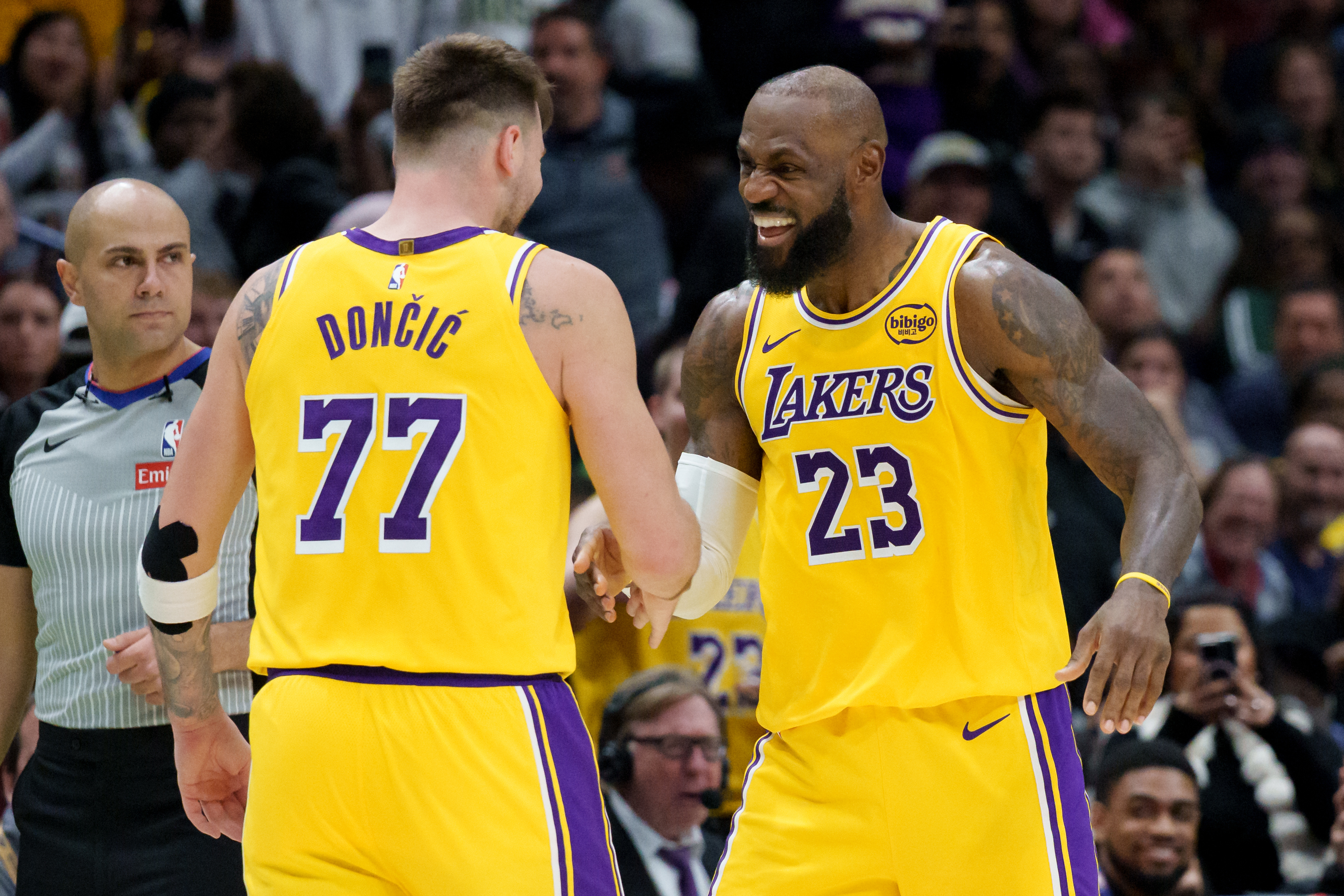 Lakers star Luka Doncic, left, celebrates a 3-point basket with teammate LeBron James during the second half of their victory over the New Orleans Pelicans on Tuesday night in New Orleans. Doncic and James each scored 30 points in a 111-103 win. (AP Photo/Matthew Hinton)

