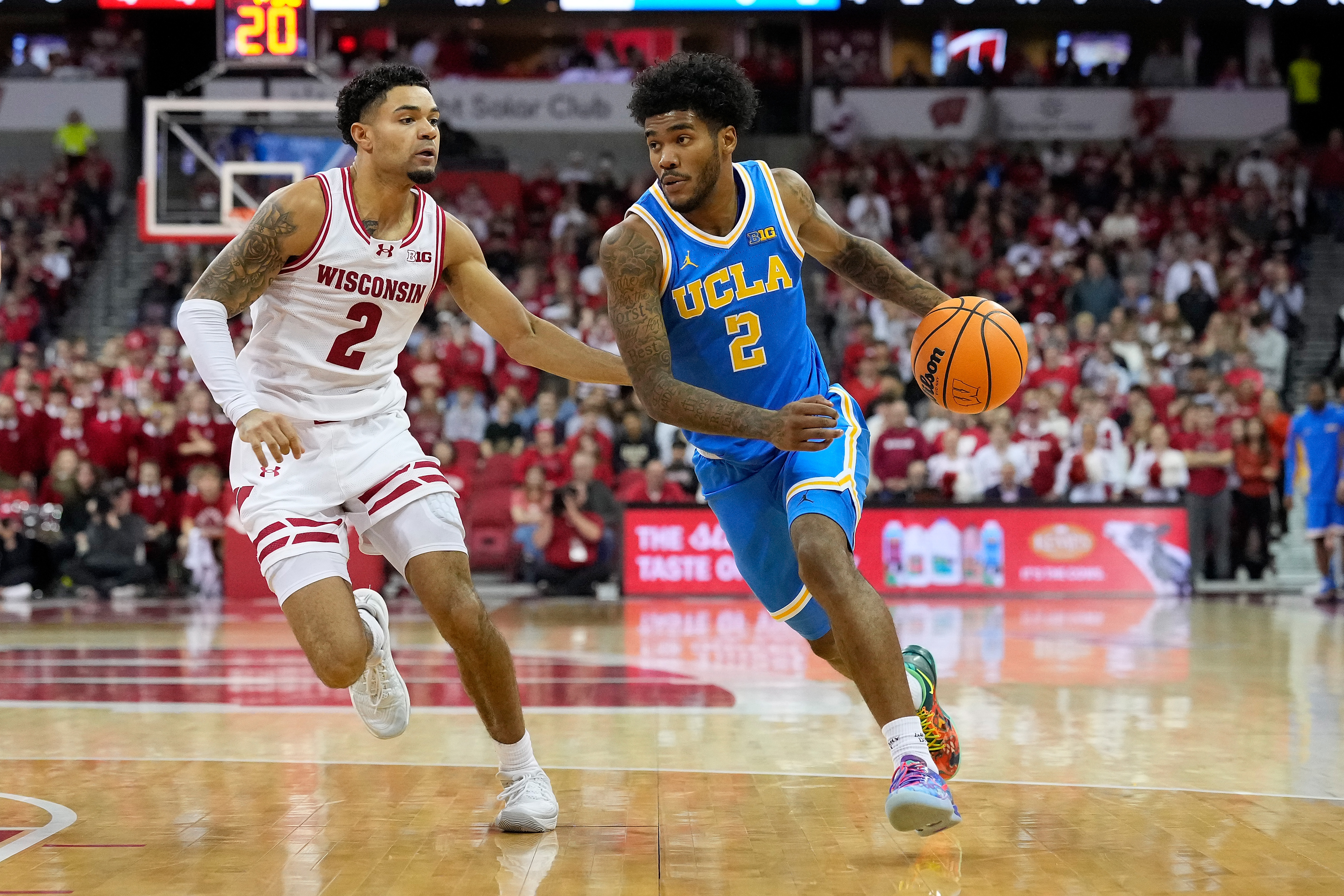 UCLA’s Donovan Dent drives to the basket as Wisconsin’s Nick Boyd defends during the first half on Tuesday night in Madison, Wis. (Photo by John Fisher/Getty Images)
